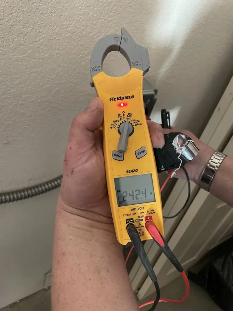 Voltage testing with clamp meter during Recessed Lighting Installation in Dwight